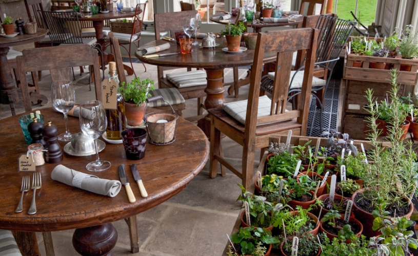 Dining tables and plants in The Garden Restaurant at The Pig-Near Bath